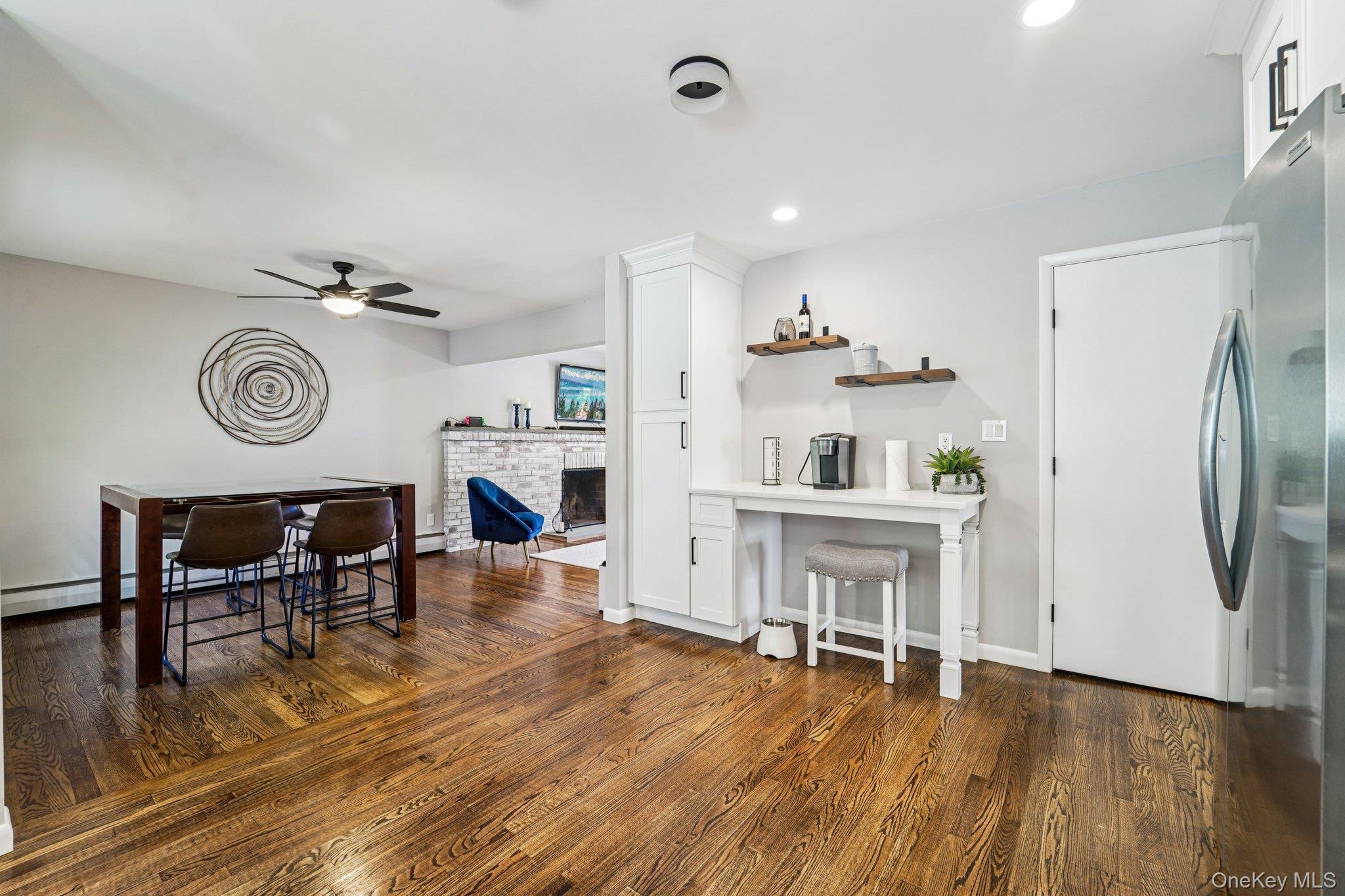 252 County Center Road White Plains, NY 10603 - Photo 10 of 44 Dining space with dark wood-style flooring, a fireplace, recessed lighting, baseboard heating, and ceiling fan