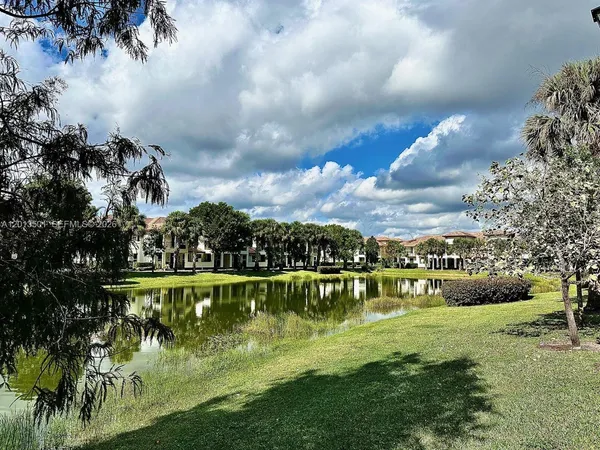 a view of a lake with houses in the back