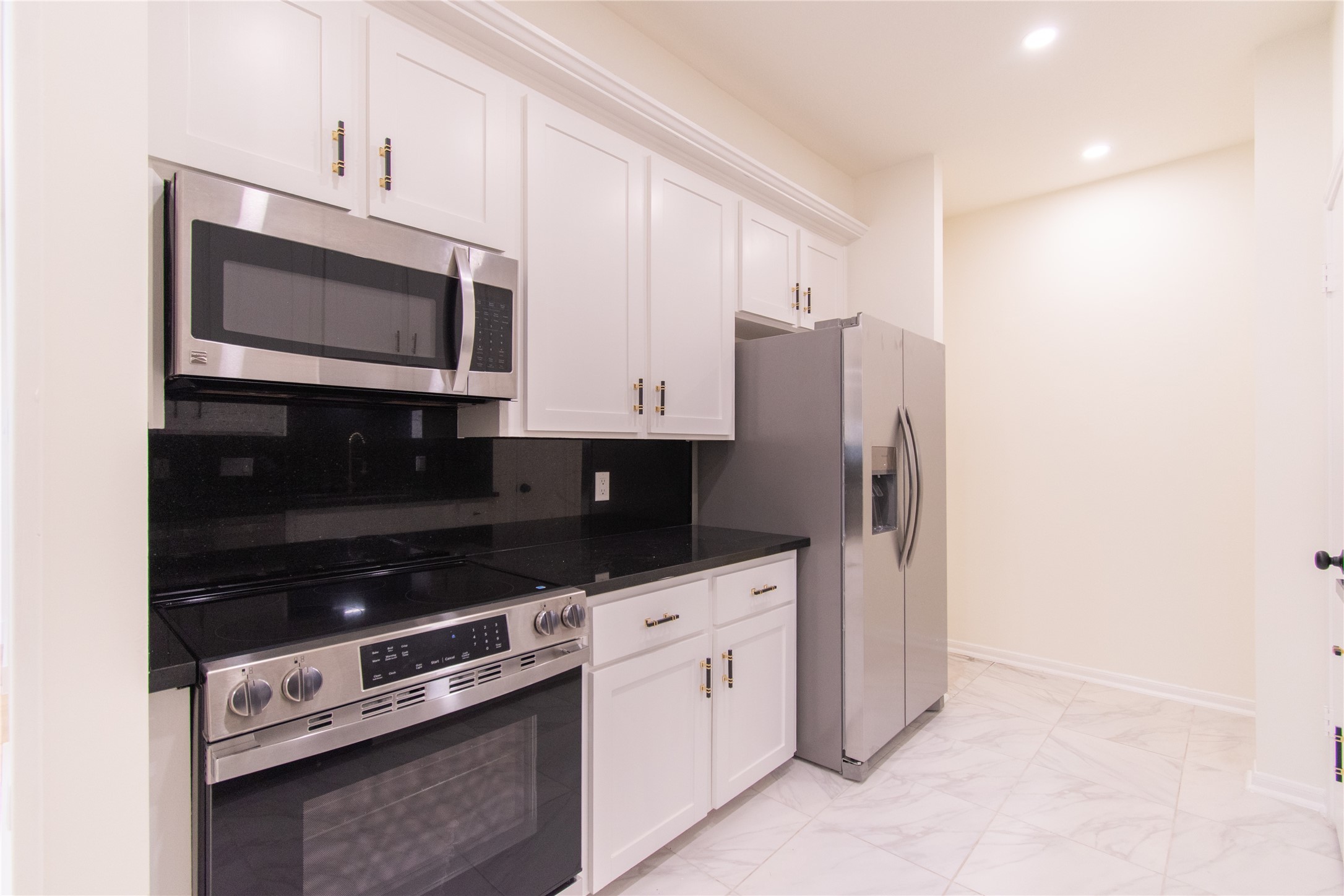 727 Bunker Hill Road, Unit 43 Houston, TX 77024 - Photo 14 of 34 The space is well-lit with recessed lighting and has a clean, modern look with light tiled flooring.