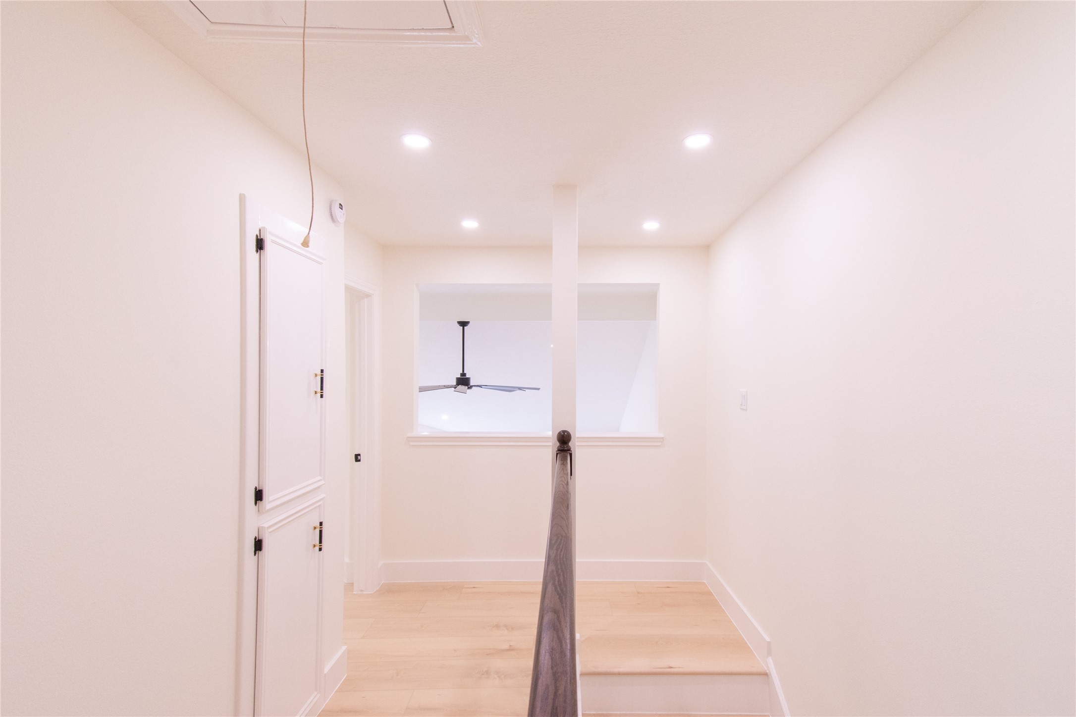 727 Bunker Hill Road, Unit 43 Houston, TX 77024 - Photo 21 of 34 Bedroom features a small window overlooking the room below and a simple railing, creating an open and airy feel.