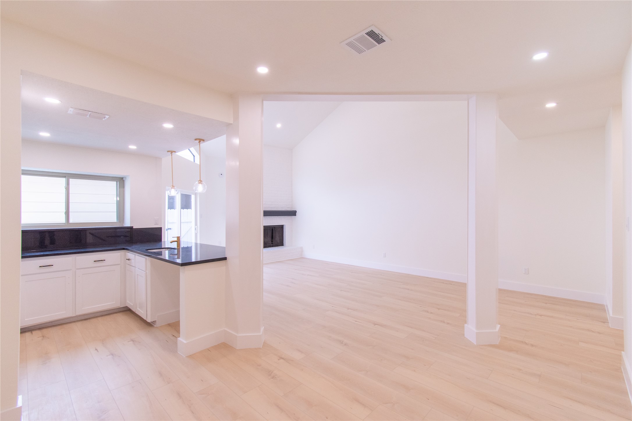 727 Bunker Hill Road, Unit 43 Houston, TX 77024 - Photo 5 of 34 A cozy fireplace is set against a high, white wall, enhancing the spacious feel.
