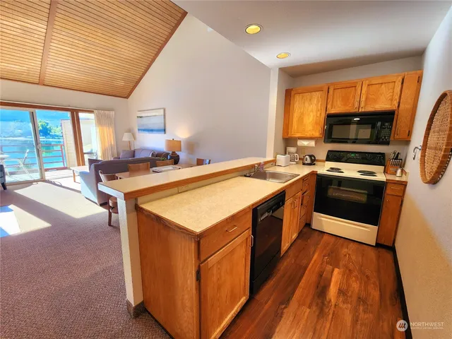 a kitchen with a stove a sink and a microwave