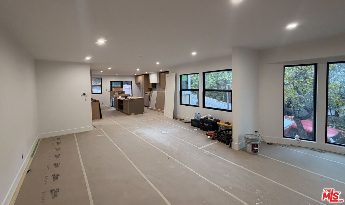a living room with furniture and large windows