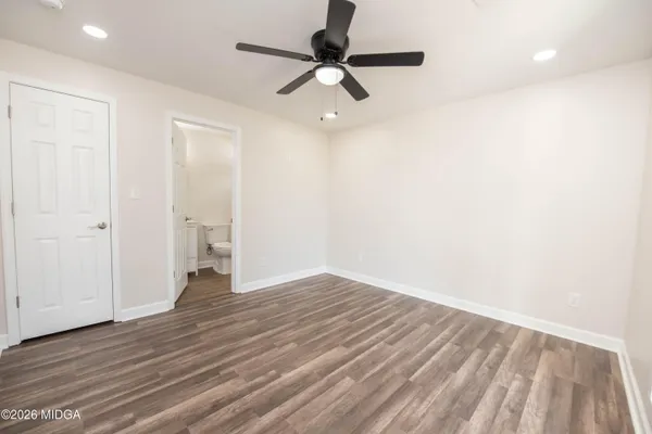 a view of an empty room with wooden floor