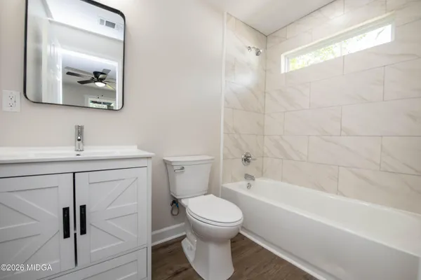 a bathroom with a toilet sink and a mirror