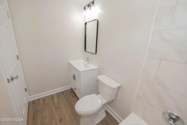 a white toilet sitting next to a bathroom sink