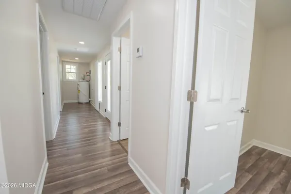 a view of a hallway with wooden floor