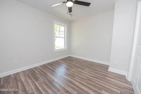 wooden floor in an empty room with a window