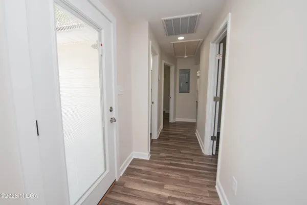 a view of a hallway with wooden floor