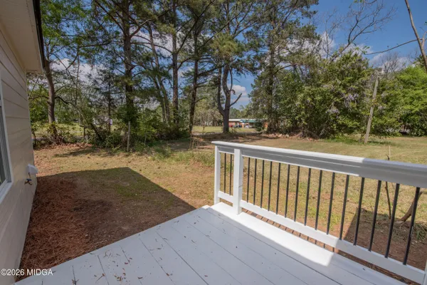 a view of a backyard with wooden fence