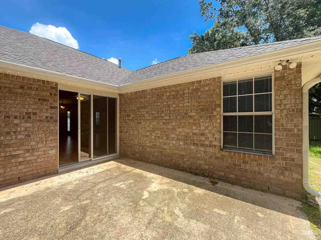 a view of a brick house with a large window