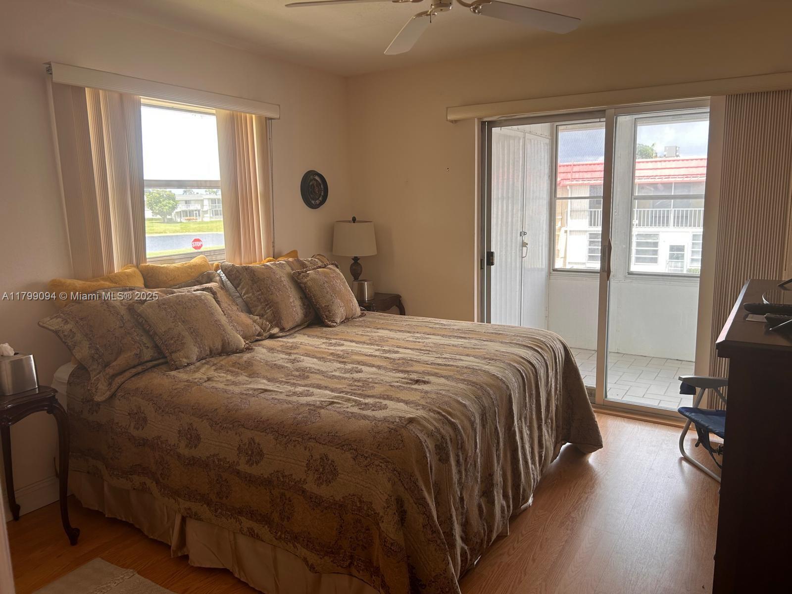 92 Saxony B, Unit B Delray Beach, FL 33446 - Photo 5 of 9 a bedroom with a bed and a window