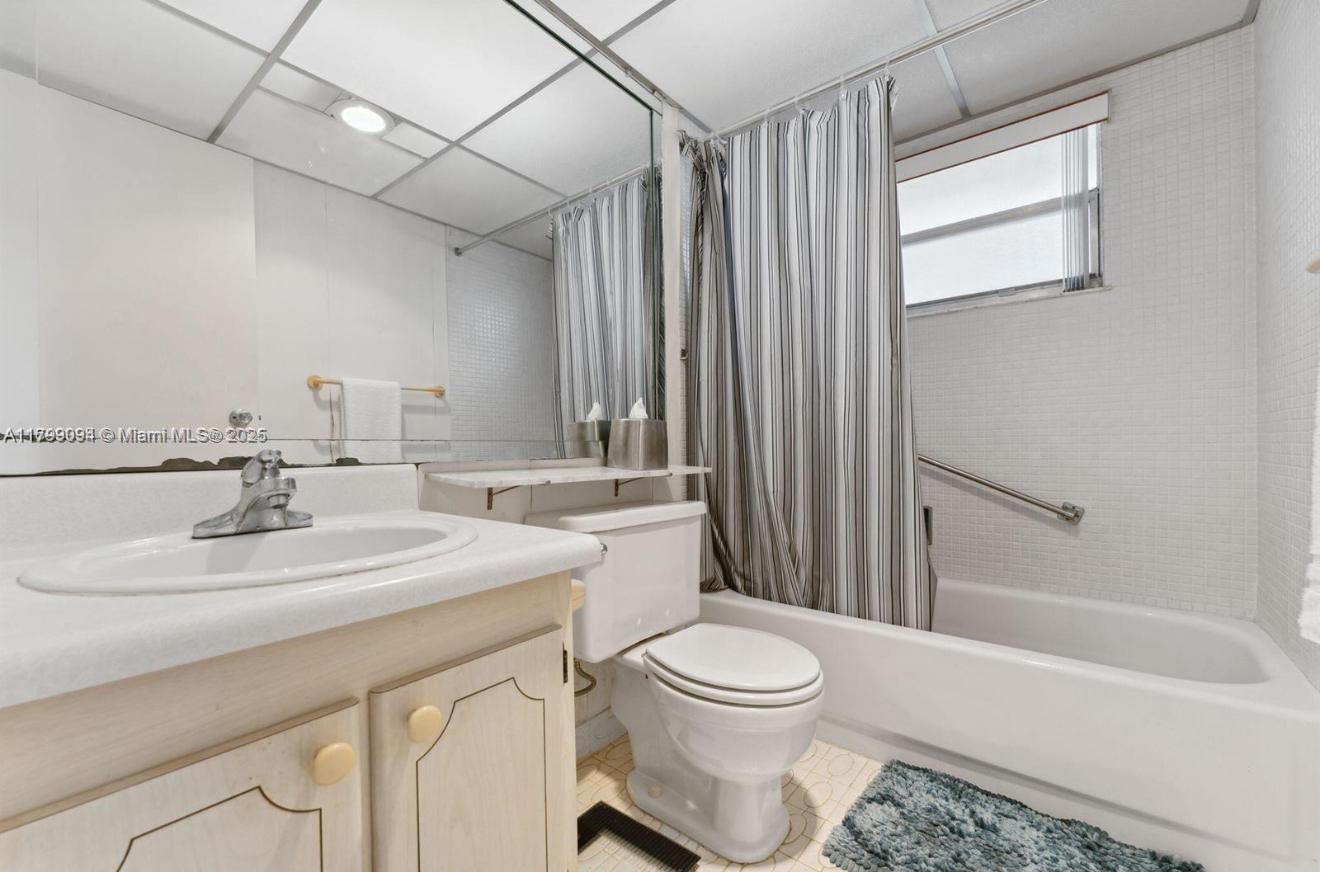 92 Saxony B, Unit B Delray Beach, FL 33446 - Photo 7 of 9 a bathroom with a sink a toilet and shower