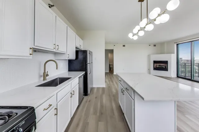 a kitchen with cabinets a sink and appliances