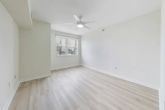 wooden floor in an empty room with a window