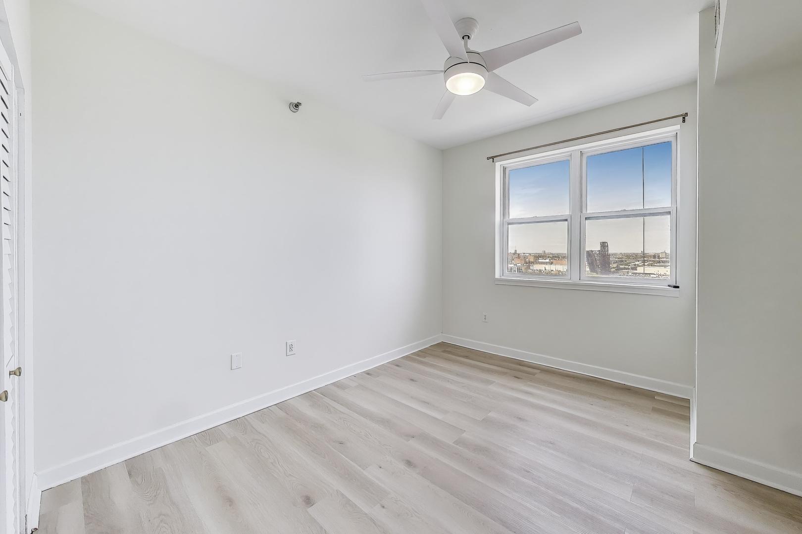5 East 14th Place, Unit 1405 Chicago, IL 60605 - Photo 18 of 33 an empty room with wooden floor and windows
