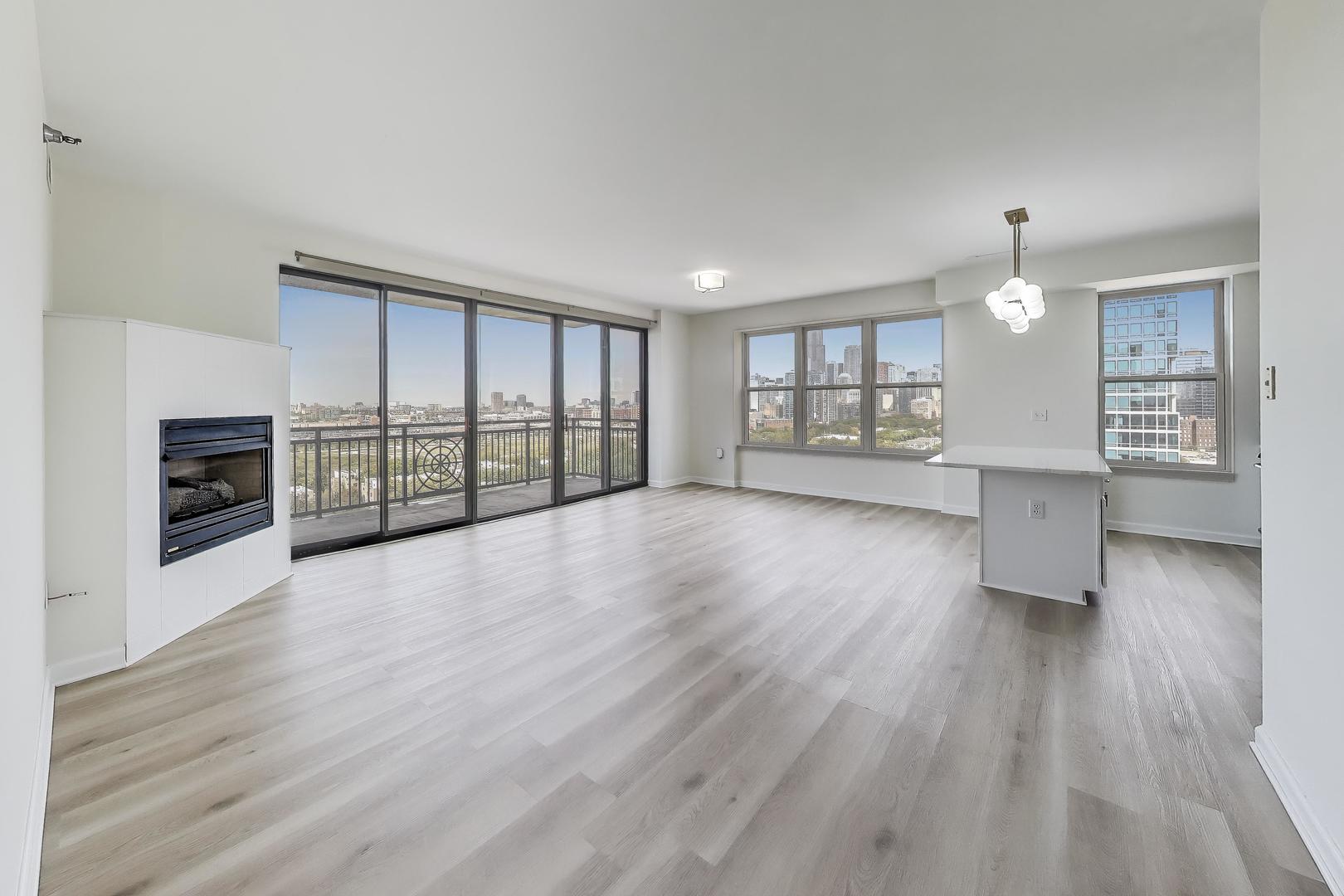 5 East 14th Place, Unit 1405 Chicago, IL 60605 - Photo 5 of 33 an empty room with wooden floor and windows