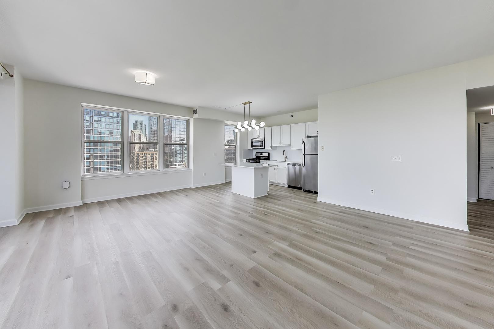 5 East 14th Place, Unit 1405 Chicago, IL 60605 - Photo 6 of 33 wooden floor in an empty room with a window