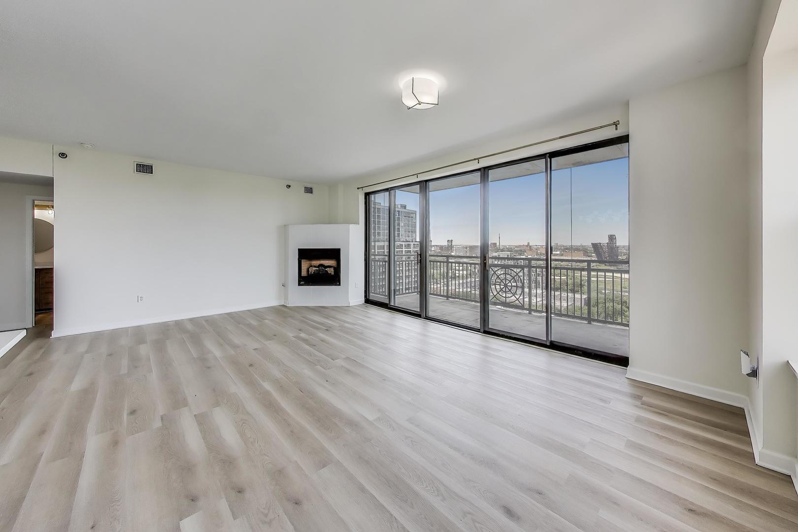 5 East 14th Place, Unit 1405 Chicago, IL 60605 - Photo 7 of 33 a view of an empty room with wooden floor and a window