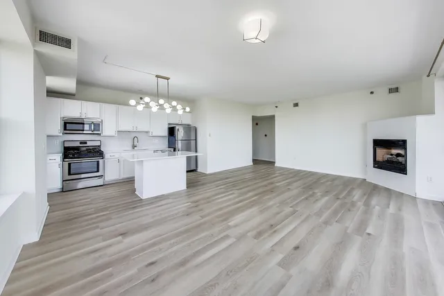 a view of a kitchen with a sink cabinets and a fireplace