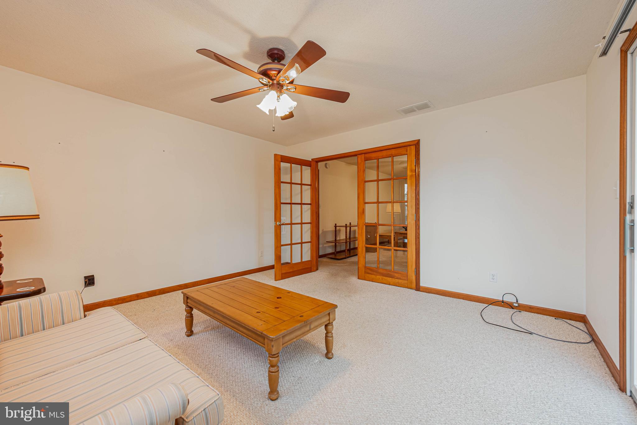 35772 Egret Road Selbyville, DE 19975 - Photo 18 of 38 a bedroom with a bed and a chandelier