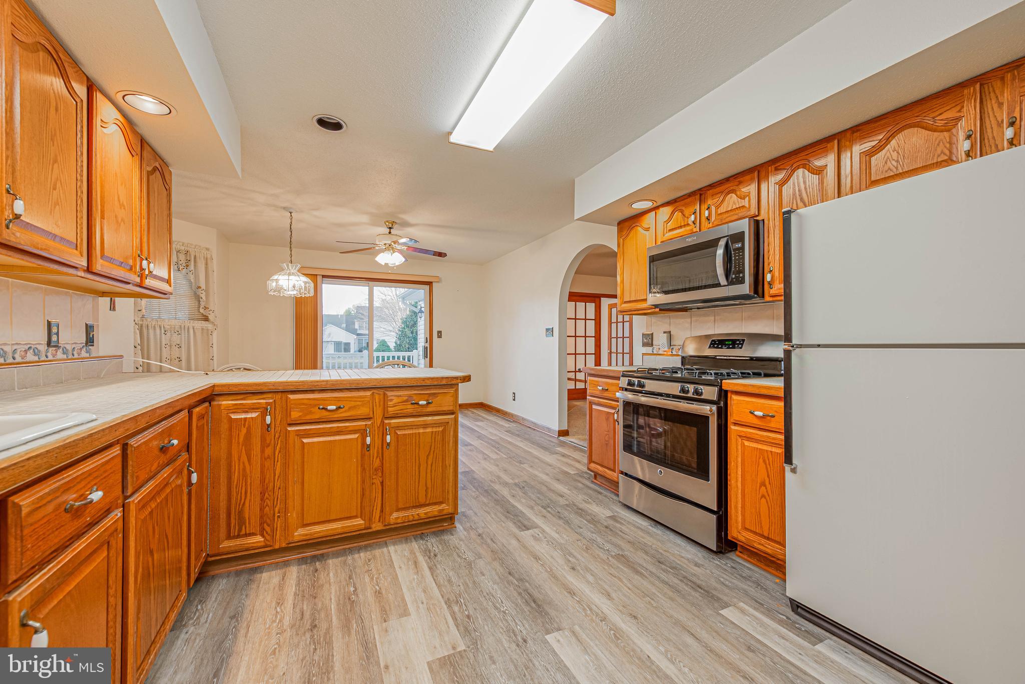 35772 Egret Road Selbyville, DE 19975 - Photo 22 of 38 a kitchen with stainless steel appliances granite countertop a stove a sink and a refrigerator