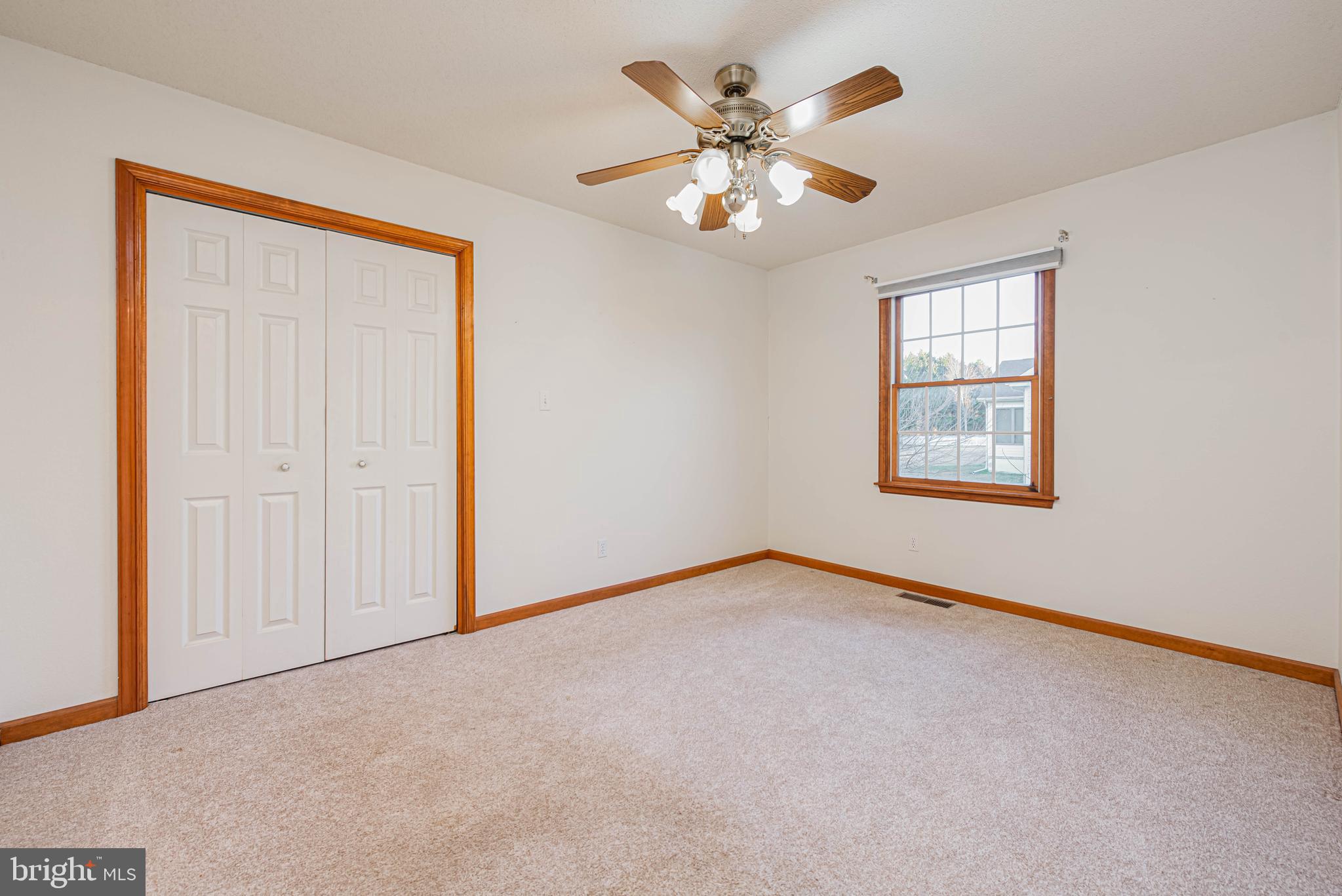 35772 Egret Road Selbyville, DE 19975 - Photo 30 of 38 an empty room with windows and chandelier fan