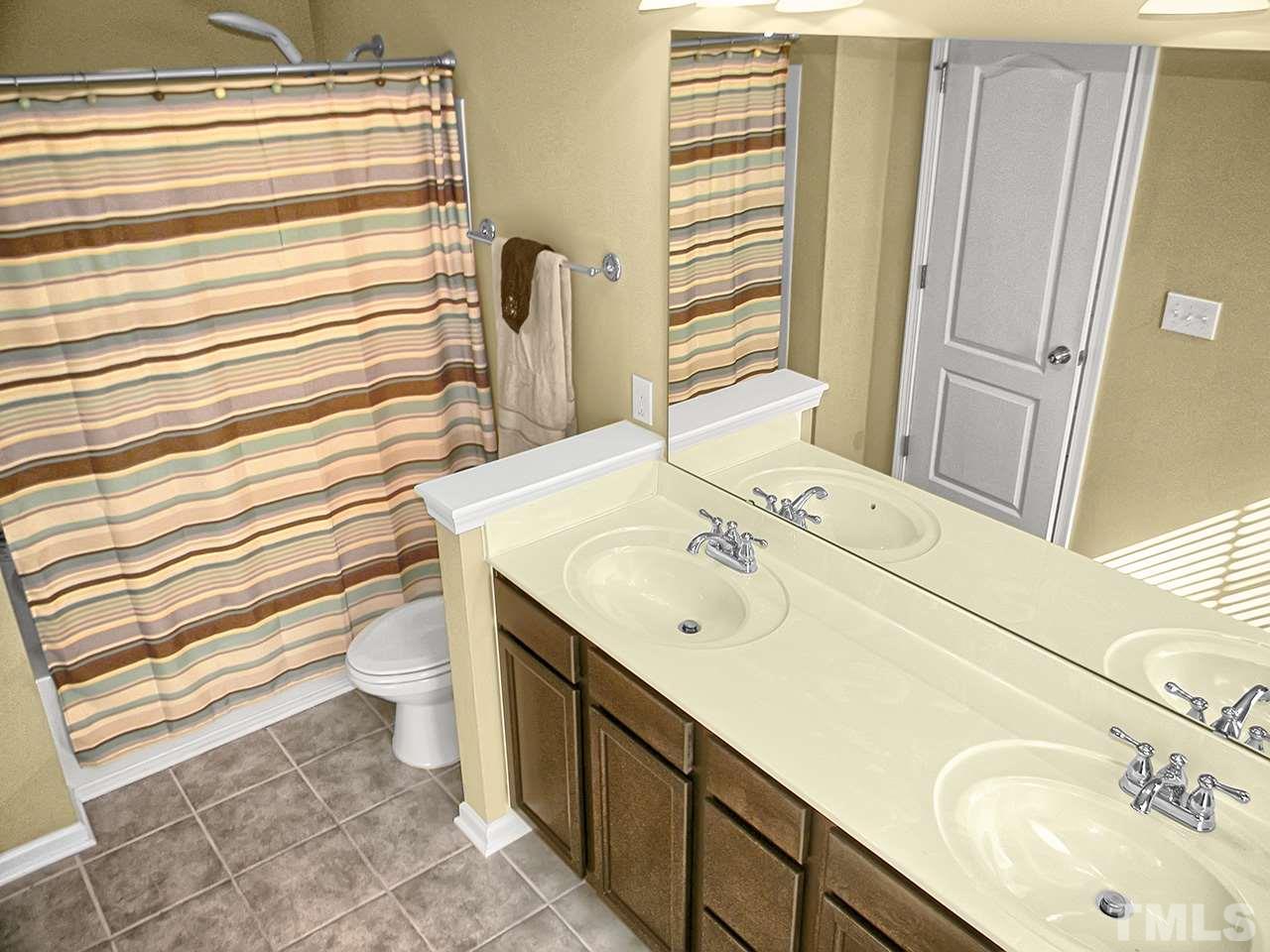4418 Cardinal Grove Boulevard Raleigh, NC 27616 - Photo 12 of 23 Dual vanities with marble counter tops. Ceramic tile floors. Large shower with garden tub.