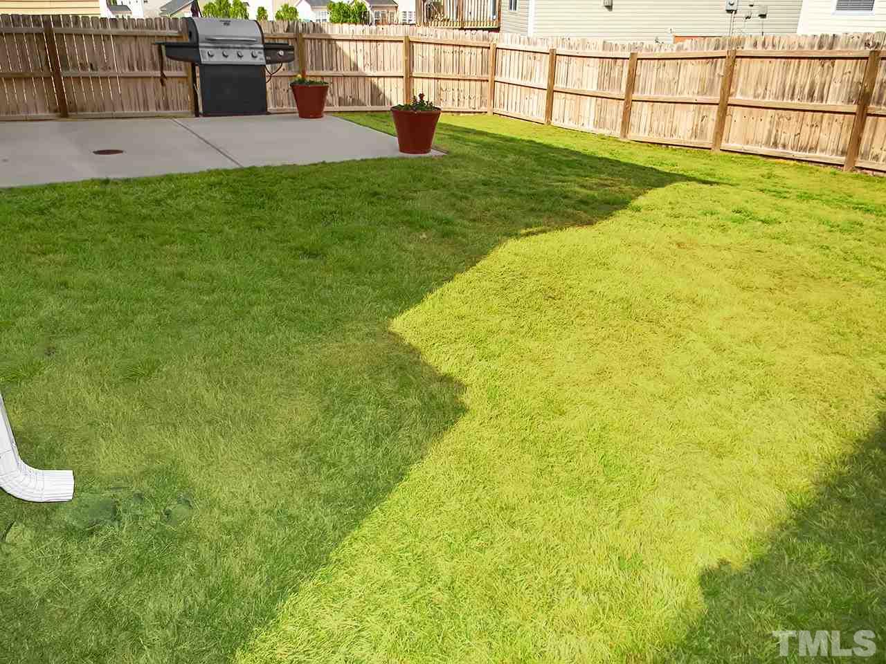 4418 Cardinal Grove Boulevard Raleigh, NC 27616 - Photo 19 of 23 Fenced-in backyard with large patio