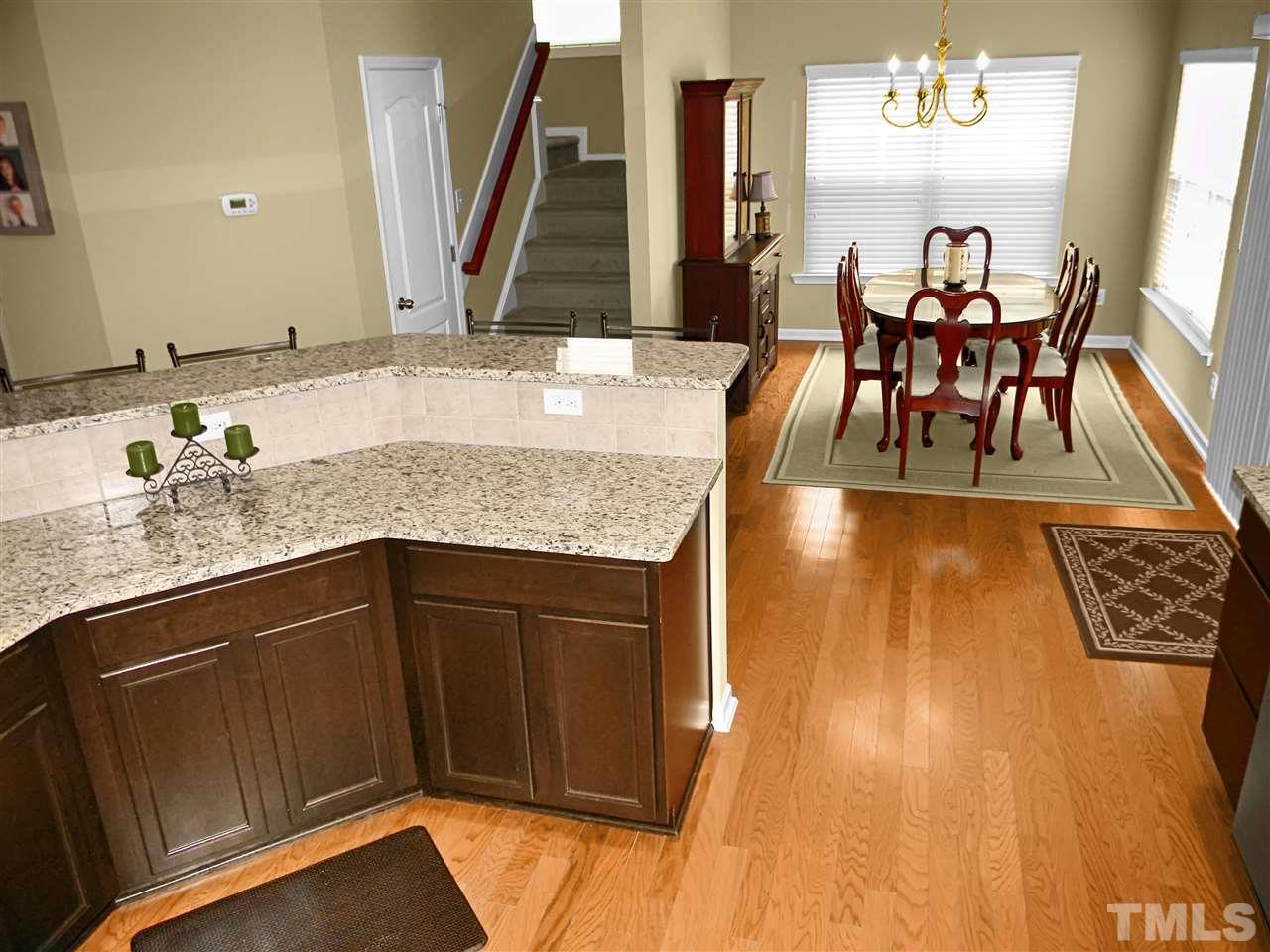 4418 Cardinal Grove Boulevard Raleigh, NC 27616 - Photo 5 of 23 View from kitchen into dining room. Large island with raised breakfast bar