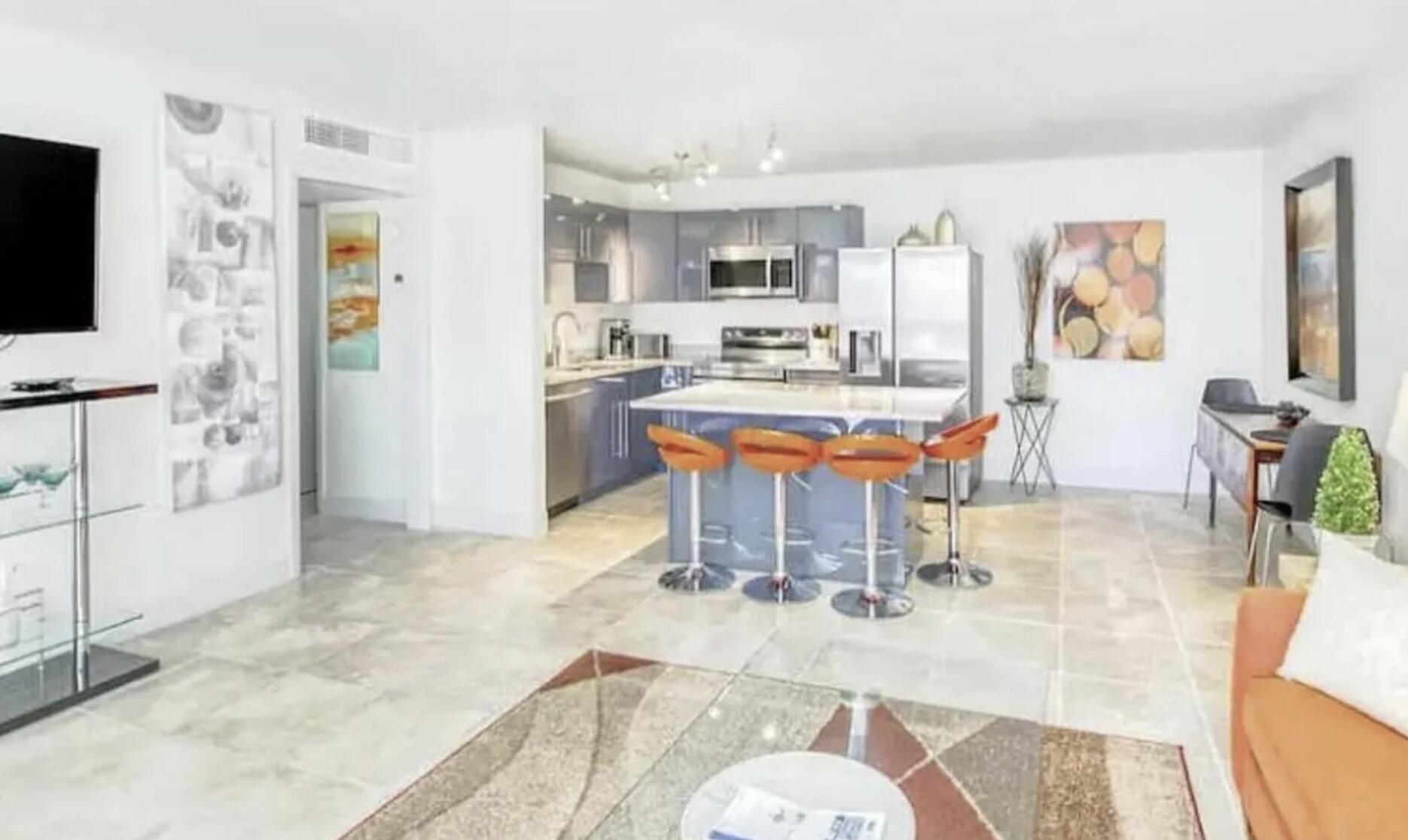 3725 South Olive Avenue, Unit A West Palm Beach, FL 33405 - Photo 1 of 35 a room with stainless steel appliances kitchen island granite countertop furniture and a flat screen tv