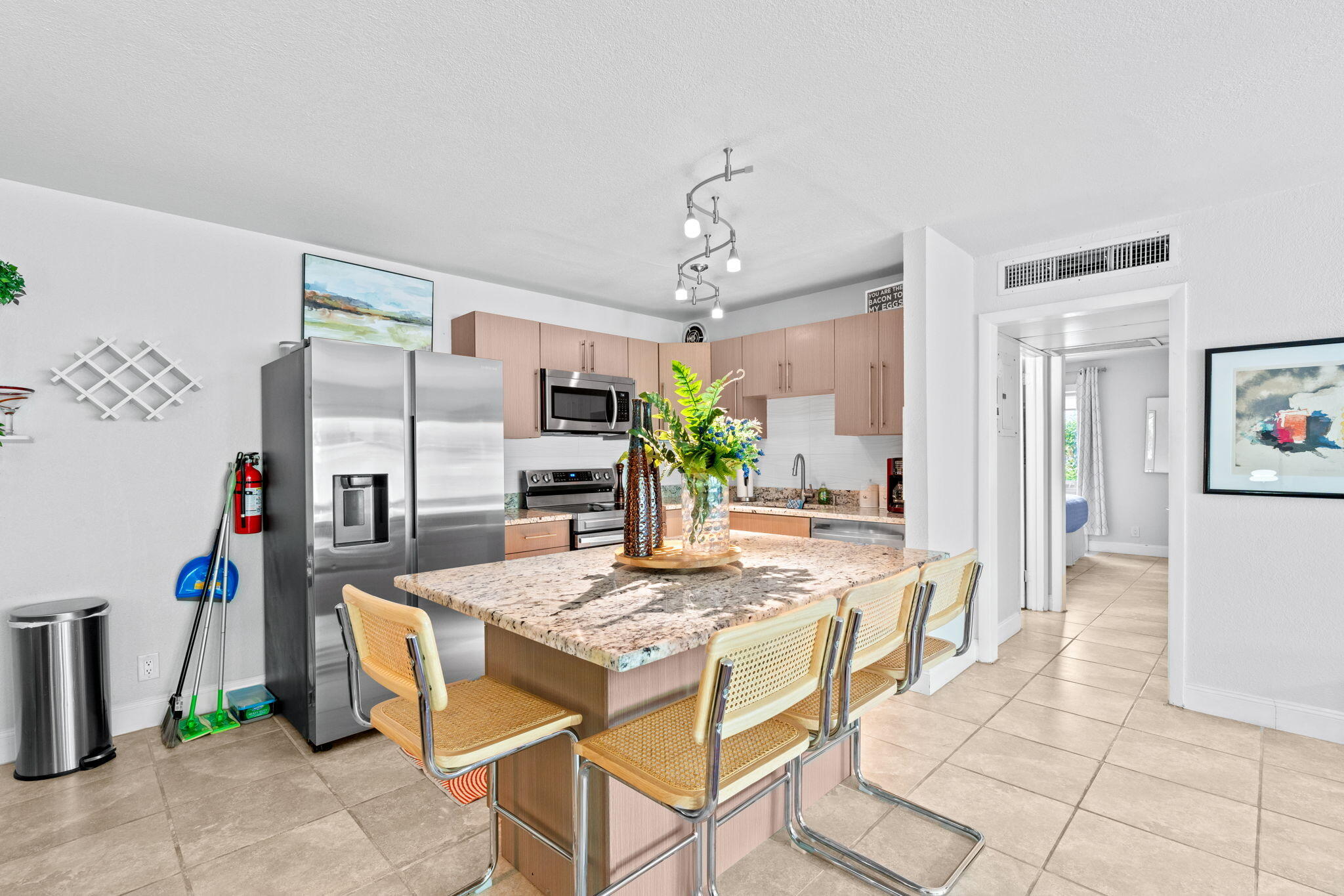 3725 South Olive Avenue, Unit A West Palm Beach, FL 33405 - Photo 15 of 35 a view of a dining room with furniture and a chandelier