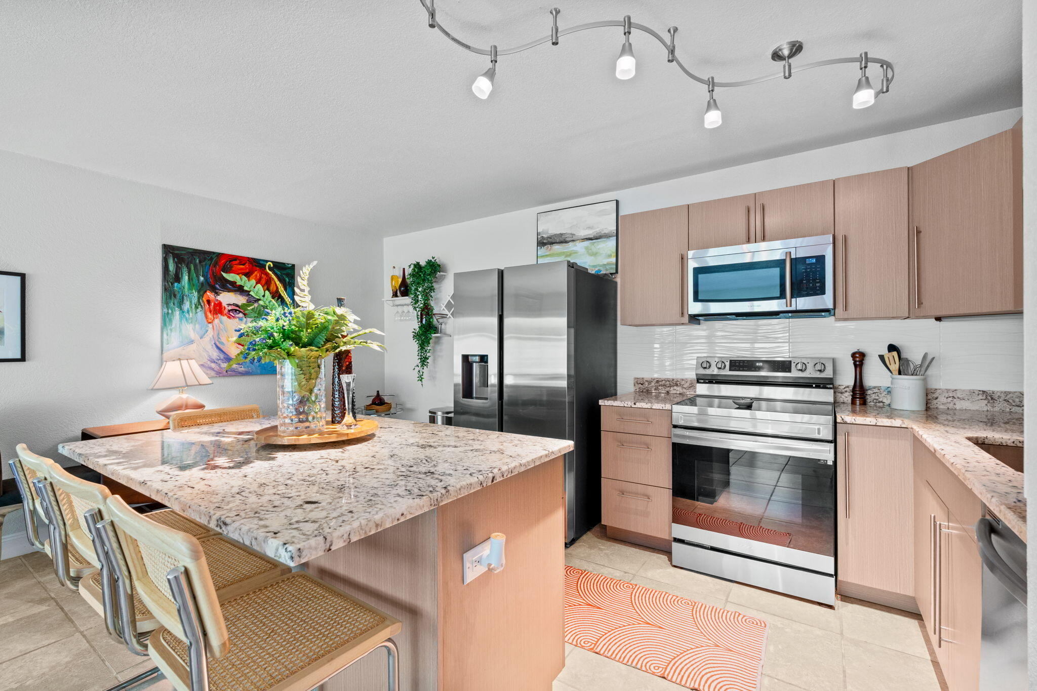 3725 South Olive Avenue, Unit A West Palm Beach, FL 33405 - Photo 16 of 35 a kitchen with stainless steel appliances kitchen island granite countertop a stove a sink and a refrigerator