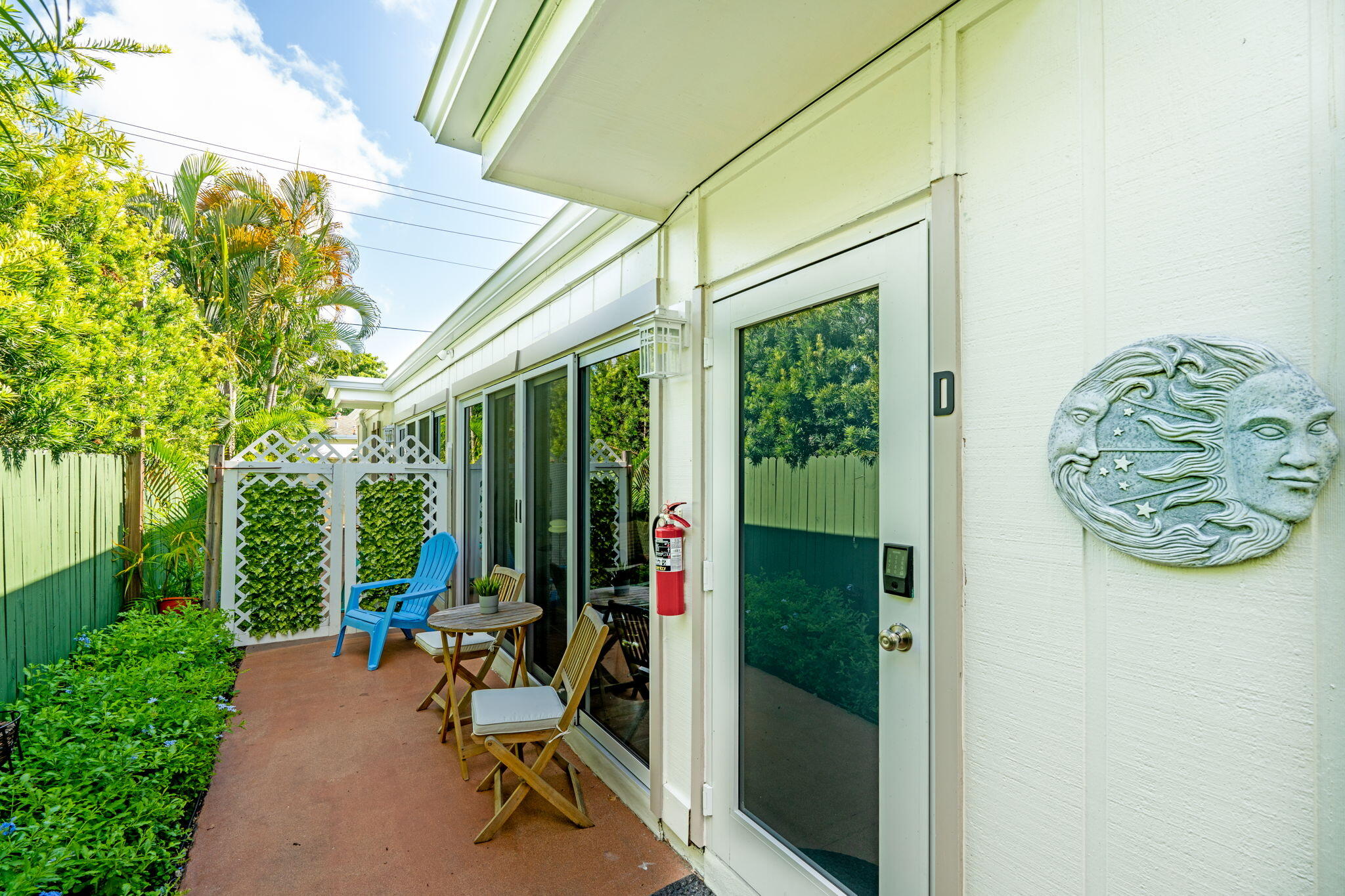 3725 South Olive Avenue, Unit A West Palm Beach, FL 33405 - Photo 2 of 35 a view of a chairs and table in a backyard