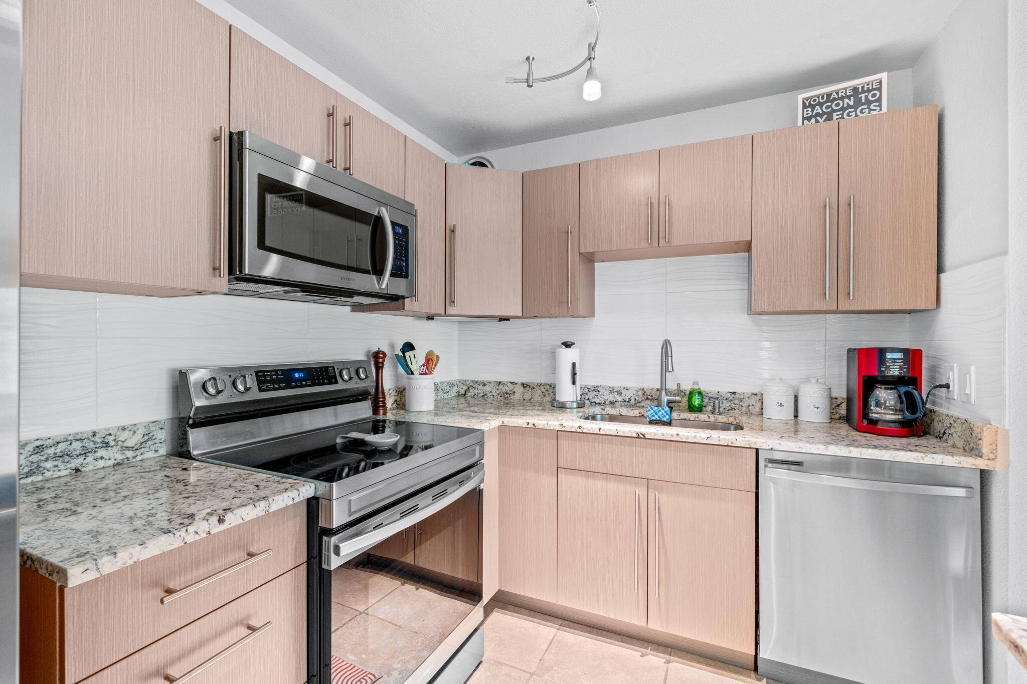 3725 South Olive Avenue, Unit A West Palm Beach, FL 33405 - Photo 21 of 35 a kitchen with a sink stove and microwave