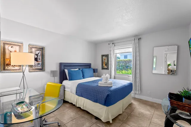 a bedroom with a bed a couch and a window