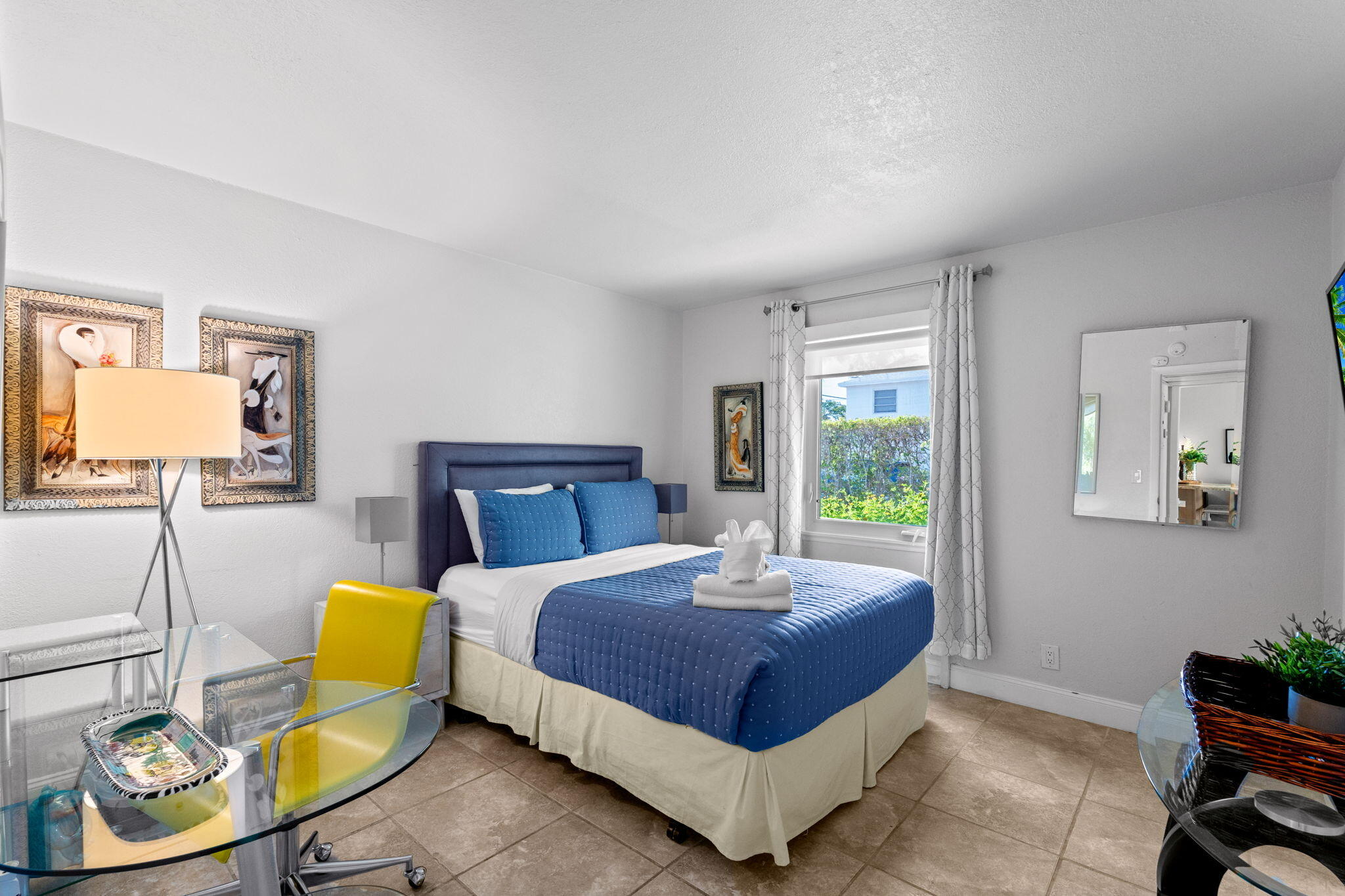 3725 South Olive Avenue, Unit A West Palm Beach, FL 33405 - Photo 26 of 35 a bedroom with a bed a couch and a window