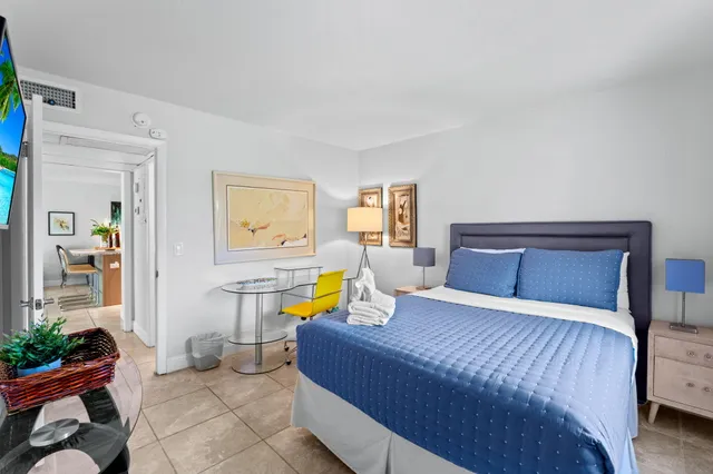 a bedroom with a bed table and couch