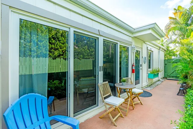 a view of a porch with chairs and backyard