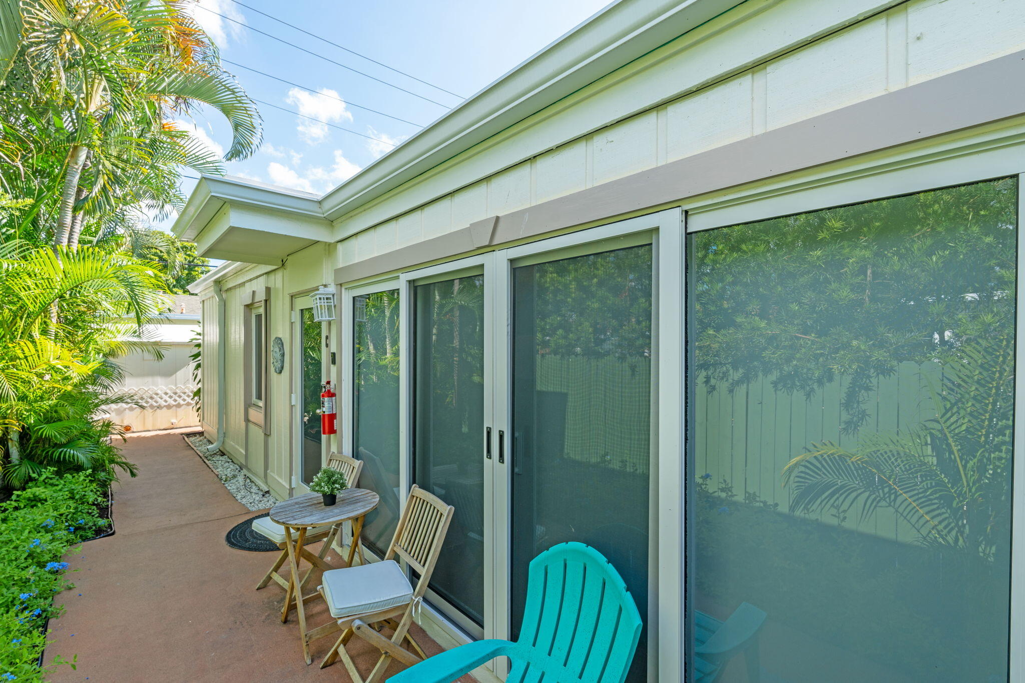 3725 South Olive Avenue, Unit A West Palm Beach, FL 33405 - Photo 33 of 35 a view of a chair and table in patio with potted plants