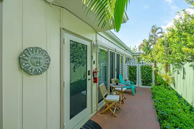a view of patio with table and chairs and potted plants