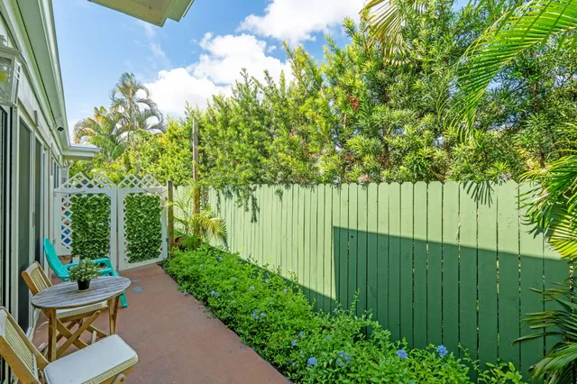 a backyard of a house with a garden and plants