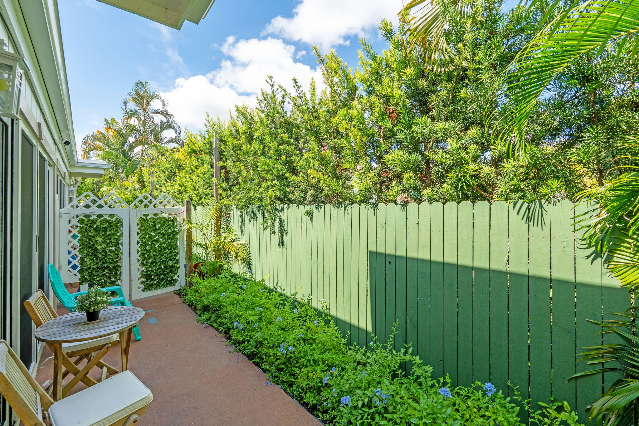 3725 South Olive Avenue, Unit A West Palm Beach, FL 33405 - Photo 35 of 35 a backyard of a house with a garden and plants