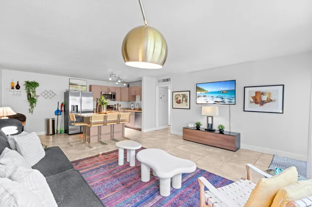 a living room with furniture a rug and a chandelier