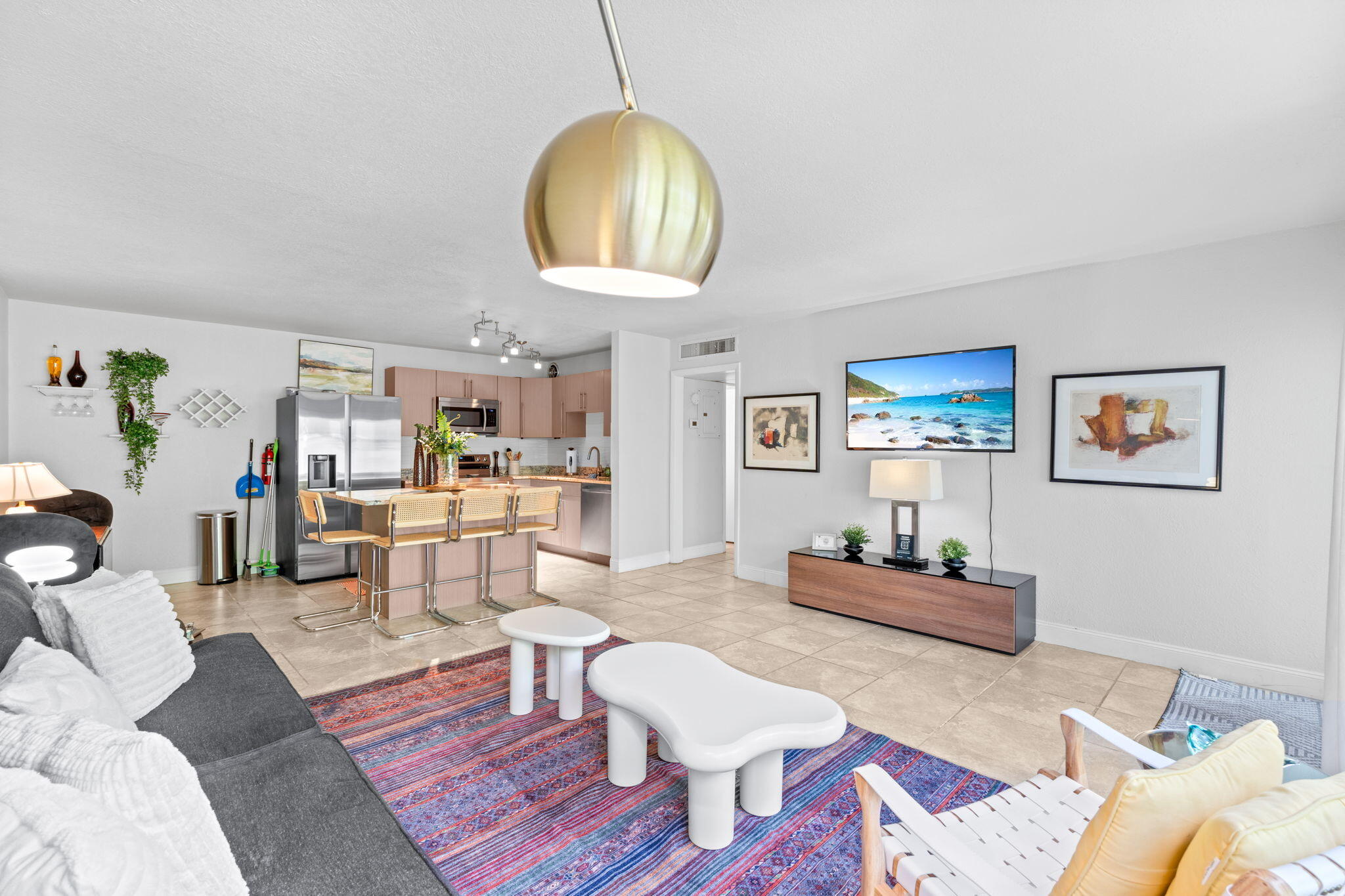 3725 South Olive Avenue, Unit A West Palm Beach, FL 33405 - Photo 8 of 35 a living room with furniture a rug and a chandelier