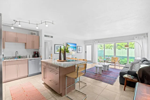 a view of a kitchen counter top space with stainless steel appliances granite countertop furniture and a sink