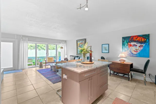 a view of kitchen with stainless steel appliances granite countertop sink and window
