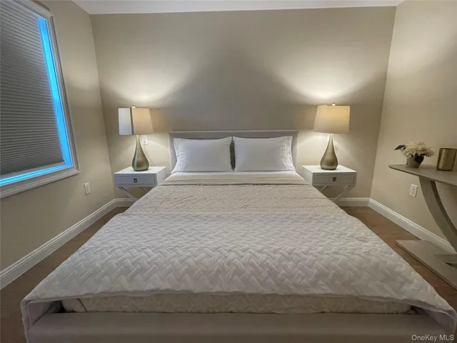 a large bed sitting in a bedroom next to a lamp