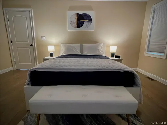 a bed room with a bed and a painting