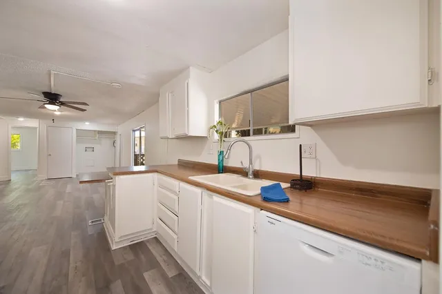 a kitchen with sink cabinets and wooden floor